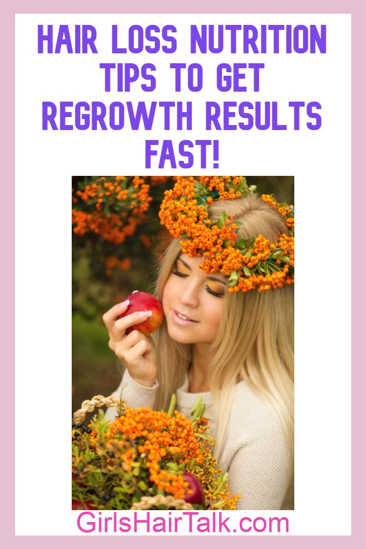 Women wearing little orange flowers as a flower crown on hair and eyes closed while holding a piece of fruit.