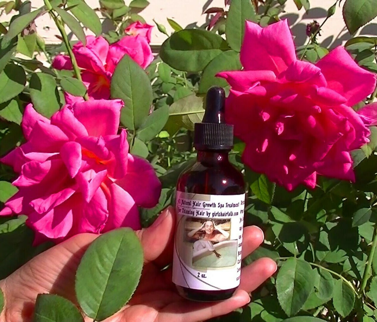 Holding with one hand a bottle of hair loss treatment for women 2 ounces. Holding my treatment bottle for hair loss.